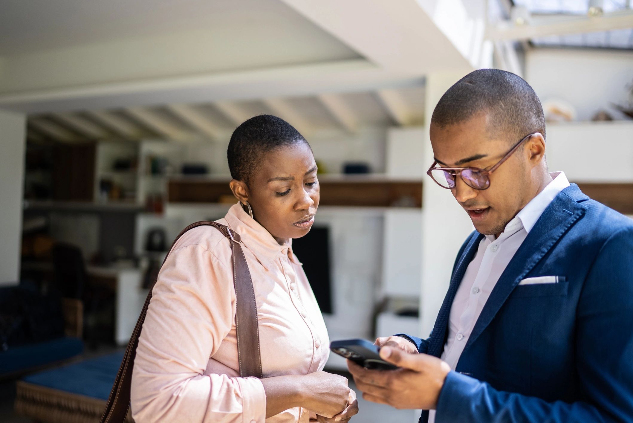 Real estate professionals discussing details inside a home